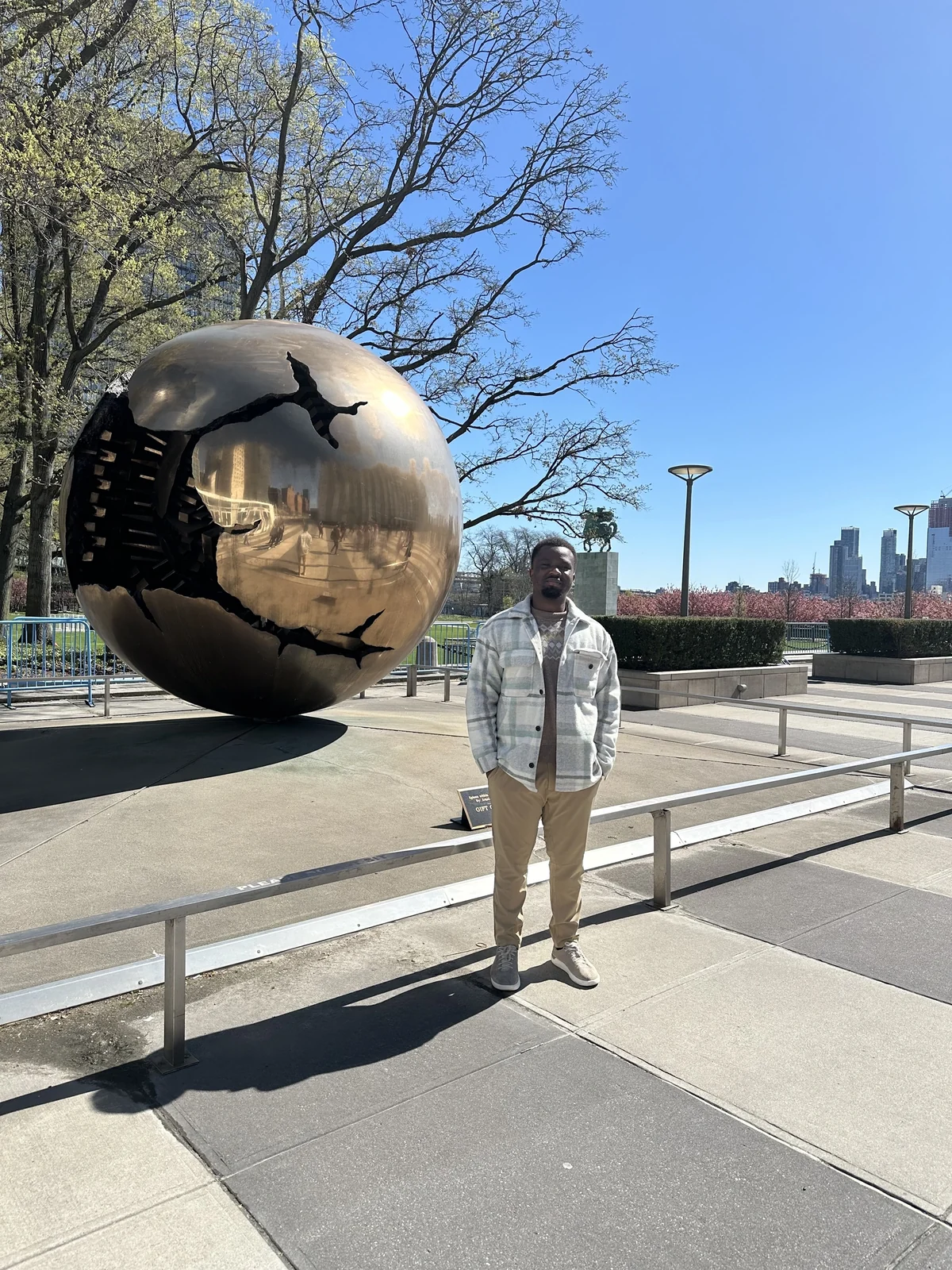 Illustrious Ewhorlu beside a bronze globe sculpture