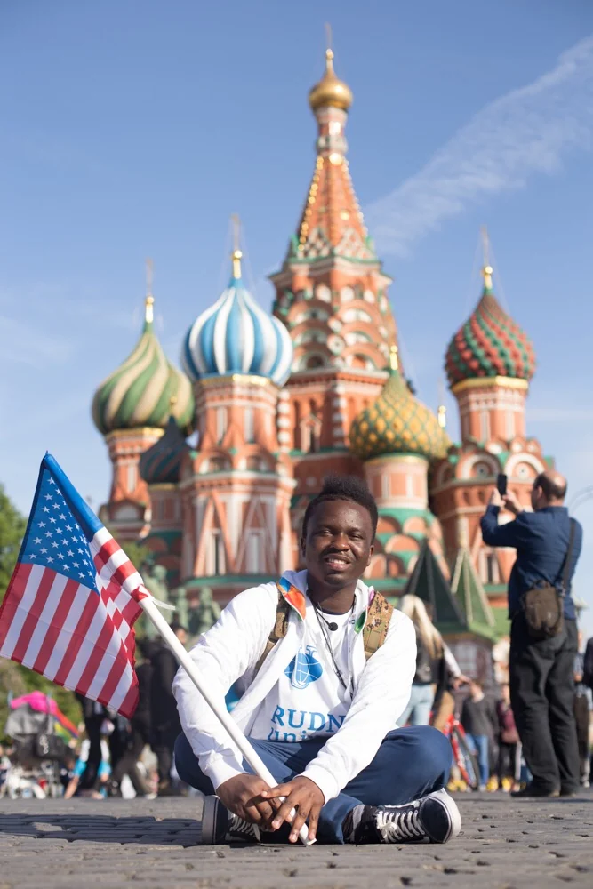 Illustrious Ewhorlu holding an American flag in Red Square, Moscow