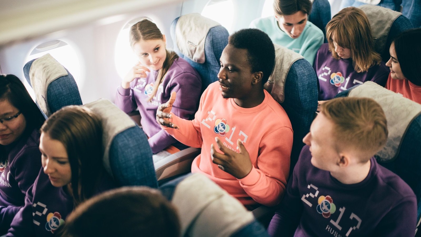 Illustrious Ewhorlu in conversation with fellow participants aboard a plane
